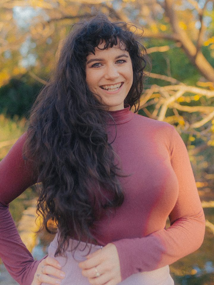 Nina Nikolic's headshot - professional Australian female voice over artist - woman smiling with hazel eyes, light skin and brown hair